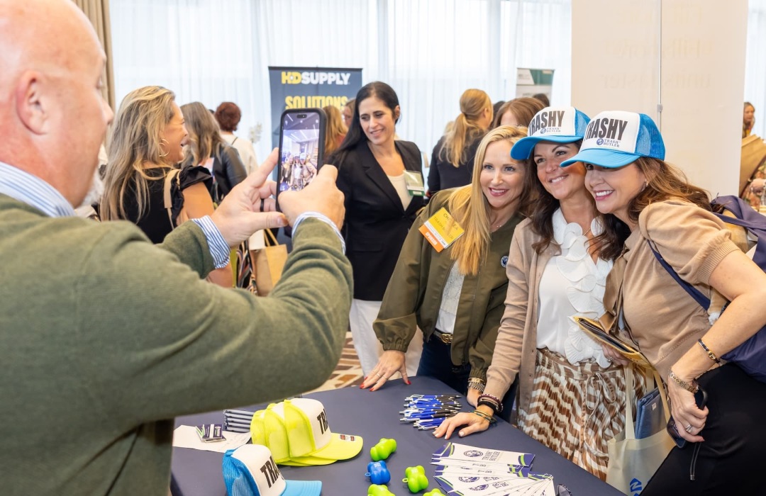 people posing at a tradeshow