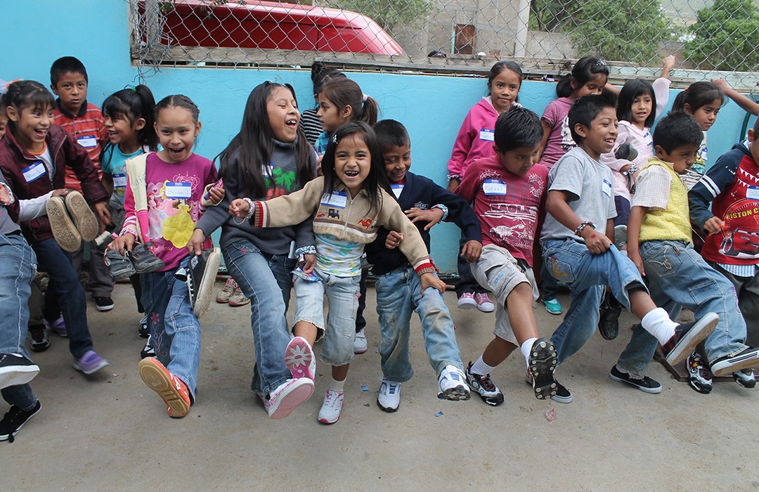 Group of kids with newly donated shoes 